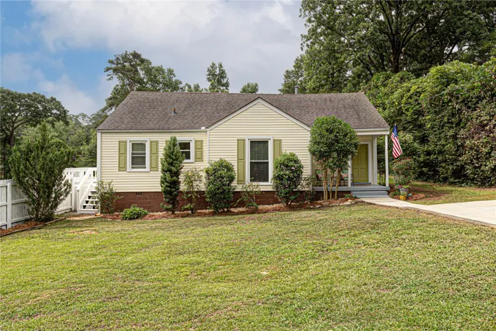 A welcoming home, framed by a great yard & landscaping, offers serene living in this charming residence.
