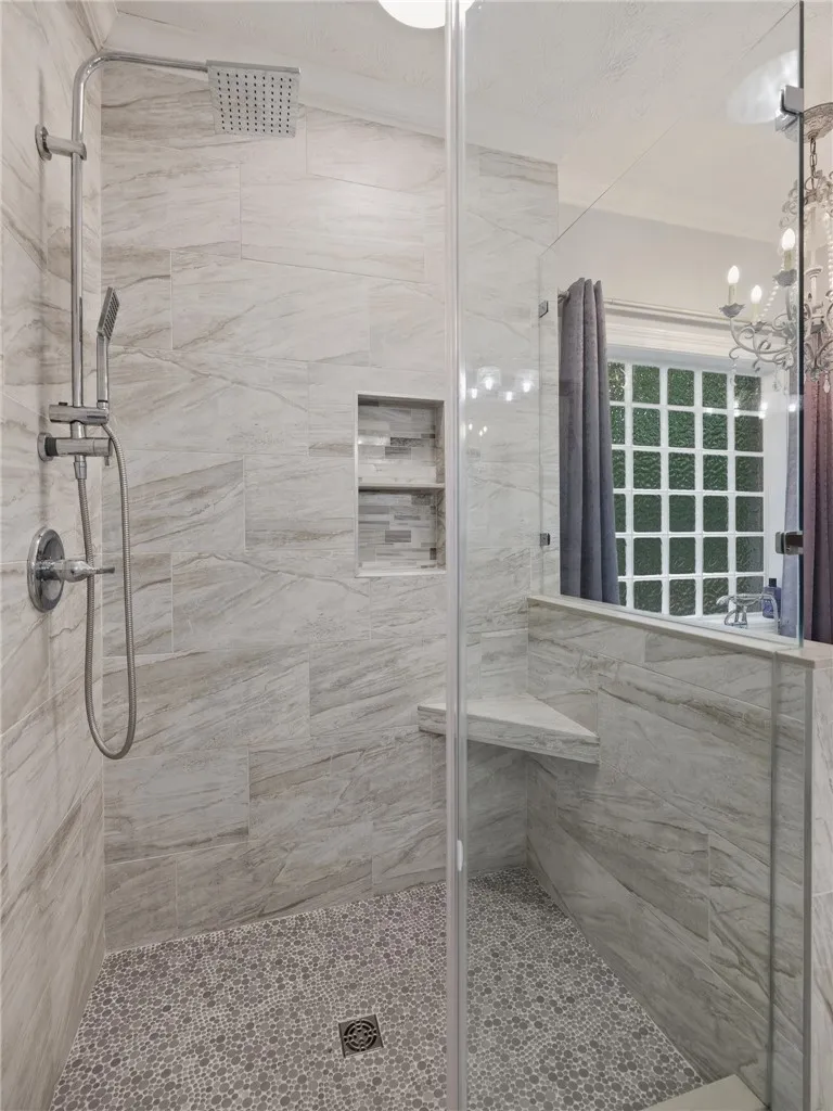Elegant tile details and premium fixtures define this modern walk-in shower design.