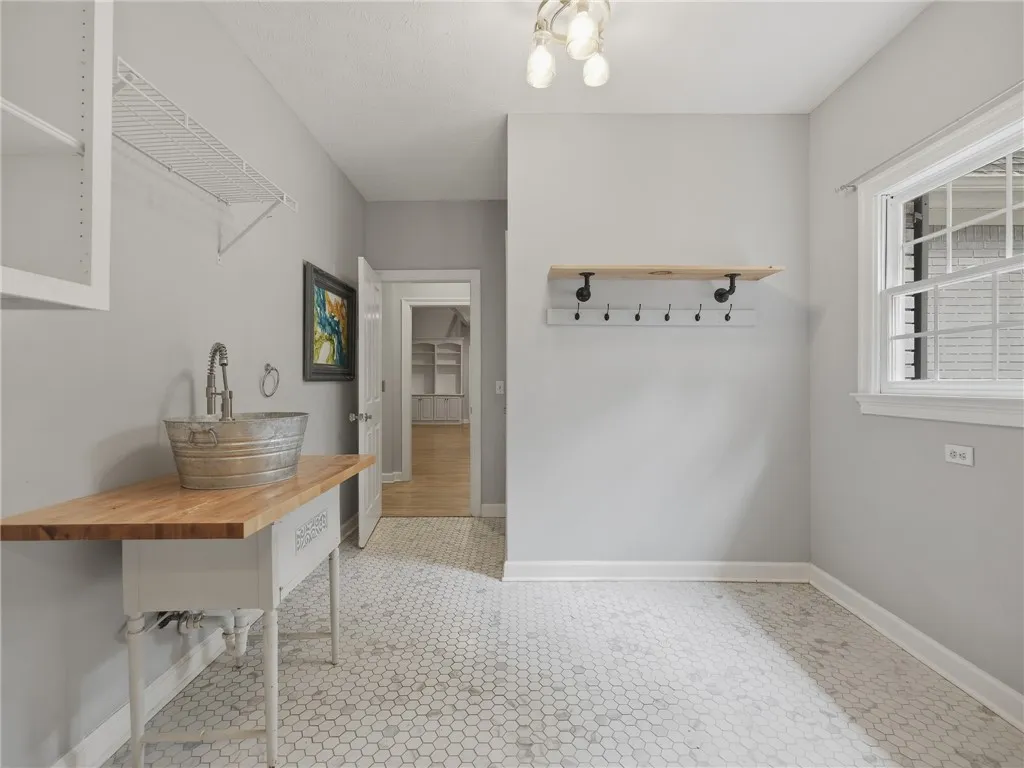 Geometric floor tile complements the modern wash station and custom built-in shelving.