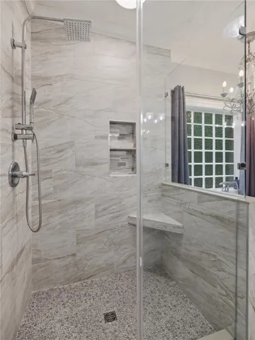 Elegant tile details and premium fixtures define this modern walk-in shower design.