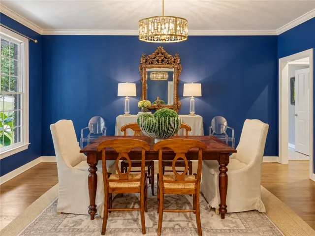 Rich hardwood flooring pairs beautifully with classic crown molding in this elegant dining room.