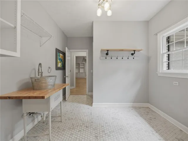 Geometric floor tile complements the modern wash station and custom built-in shelving.