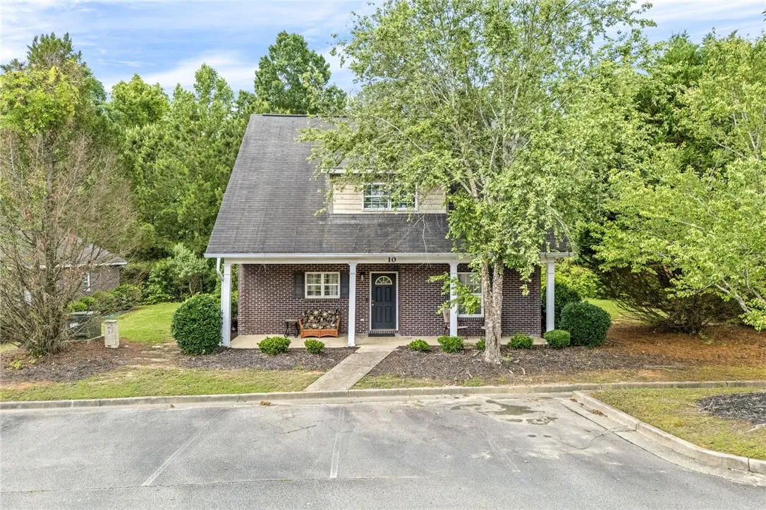 Brick facade with inviting porch and established landscaping welcomes you home.