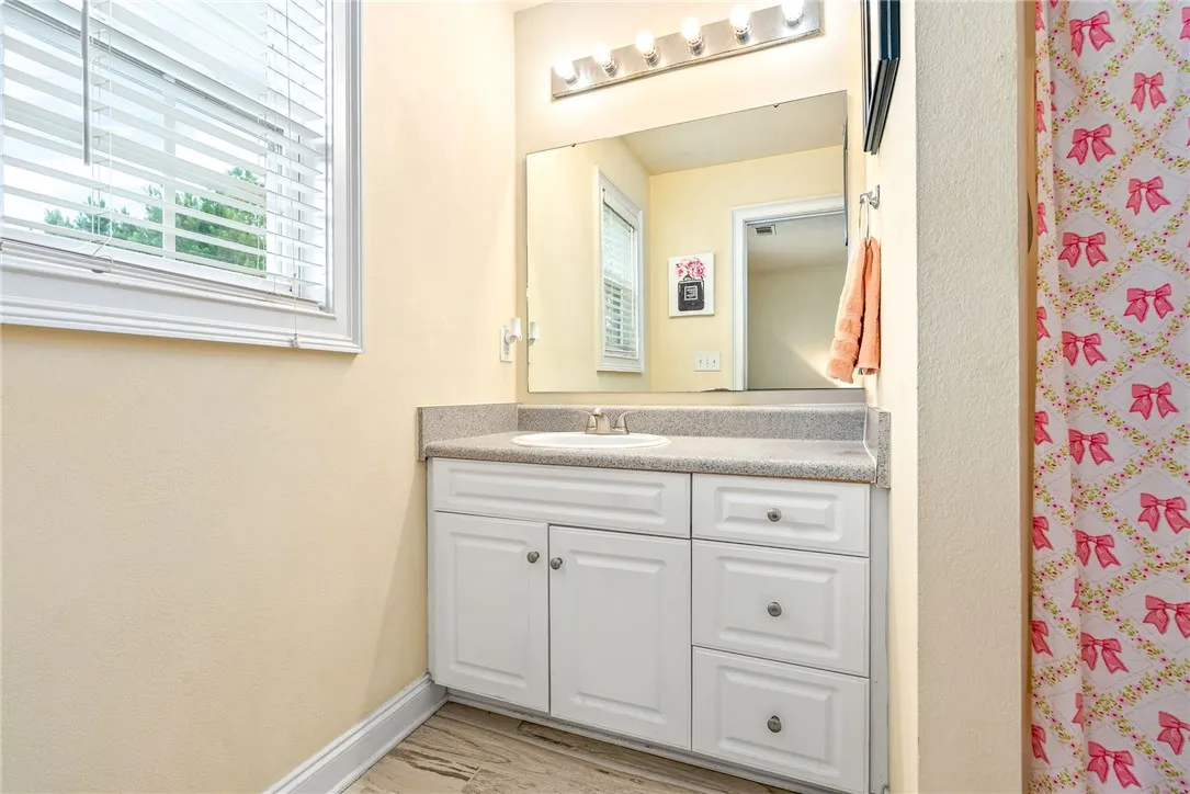 A clean, well-appointed bathroom featuring a single vanity with ample counter space and storage.