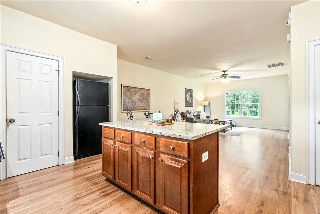 A well-appointed kitchen island offers generous counter space and storage, flowing seamlessly into the adjacent living area.