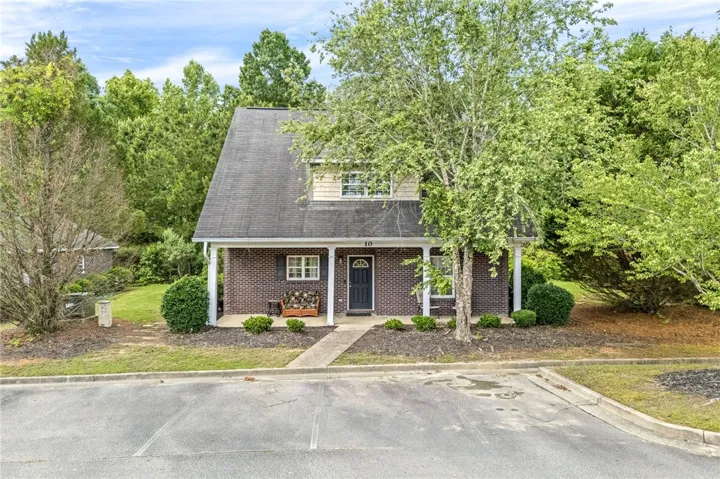 Brick facade with inviting porch and established landscaping welcomes you home.