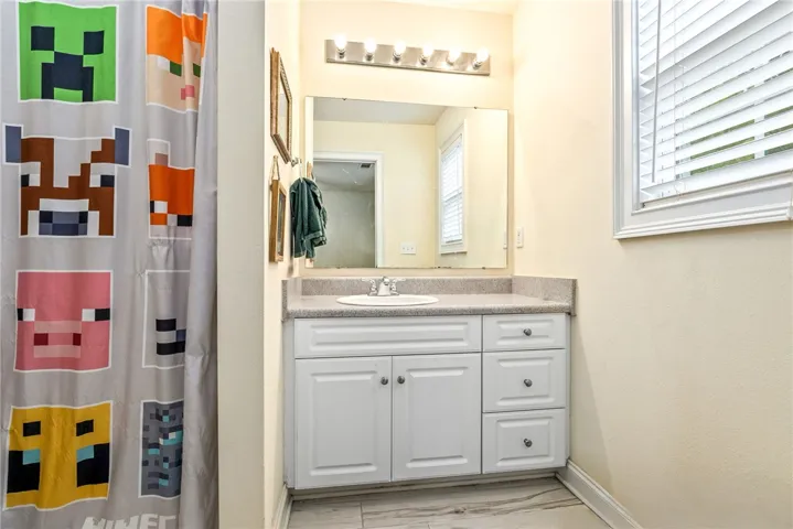 A well-appointed bathroom vanity with a bright mirror and practical storage, perfect for daily routines.