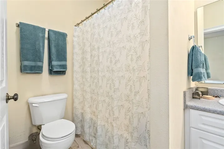 A well-appointed bath features a shower and practical vanity space.