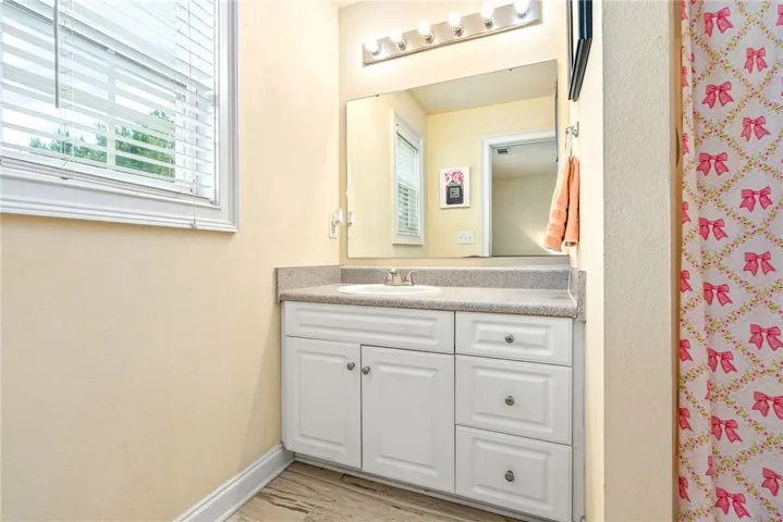 A clean, well-appointed bathroom featuring a single vanity with ample counter space and storage.