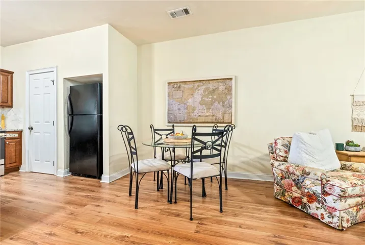 Hardwood floors flow through this welcoming dining space, ready for intimate meals or quiet reflection.