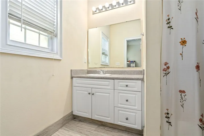 A well-appointed bathroom with vanity storage, offering functional design.