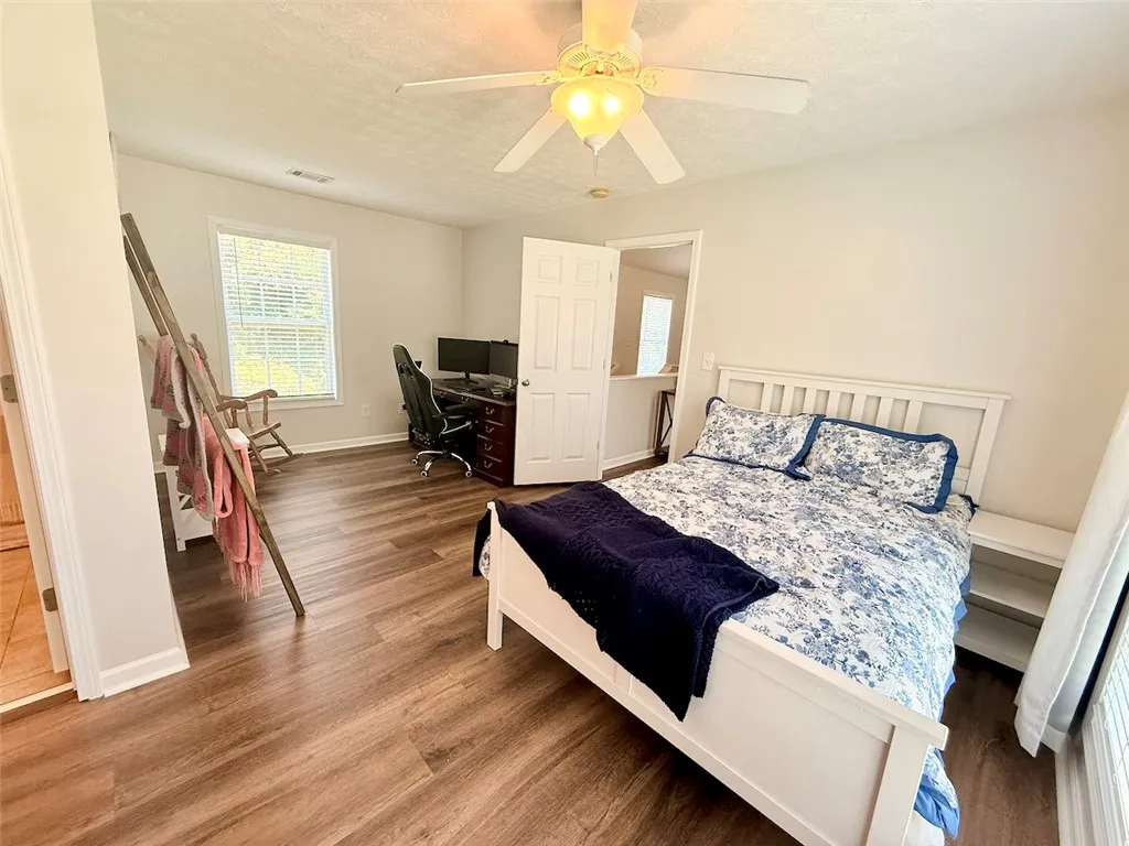 Plenty of space for a bed and a home office in this large bedroom.