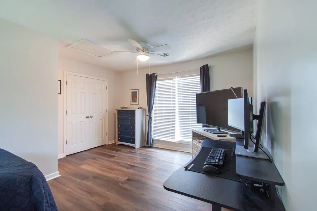 Well-appointed bedroom showcasing durable flooring and a window with natural light.