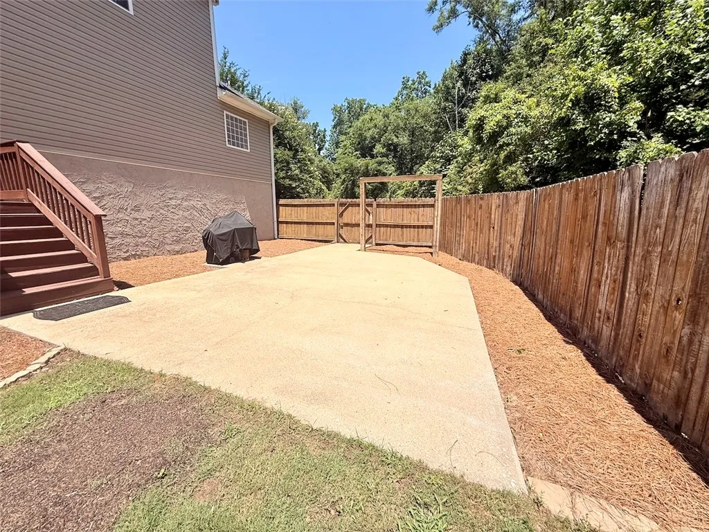 A spacious backyard with privacy fencing, perfect for outdoor entertaining.