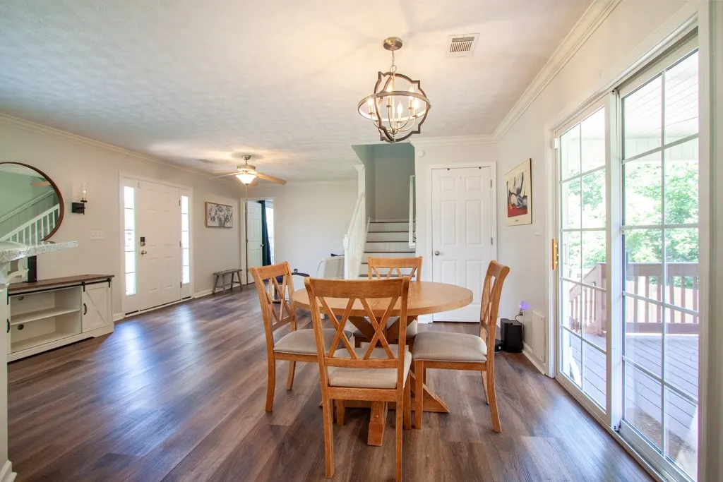 LVP flooring extends through this casual dining area, opening to a private deck for outdoor enjoyment.