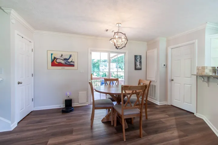 LVP flooring extends through this casual dining area, opening to a private deck for outdoor enjoyment.