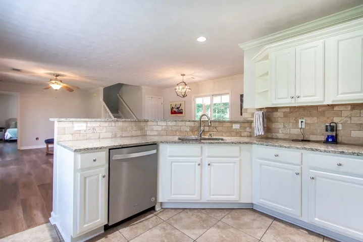 A contemporary kitchen showcasing gleaming stainless steel appliances and abundant cabinetry.