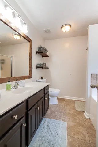 A pristine bathroom features a single vanity, a soaking tub, and a convenient shower for comfortable daily routines.