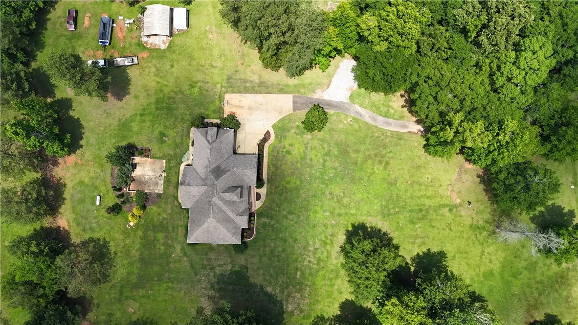 Discover a private estate with a sprawling lawn and mature trees, offering a serene escape.