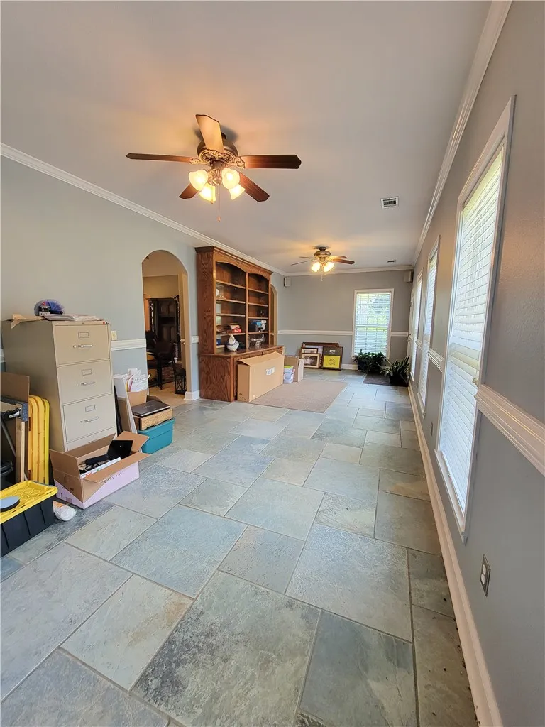 A versatile bonus room featuring large windows and robust tile flooring offers abundant natural light.