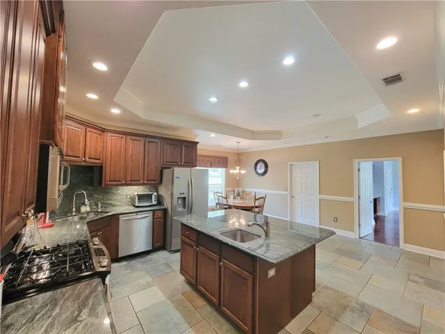 A well-appointed kitchen showcases rich cabinetry and modern appliances, creating a functional and appealing culinary space.