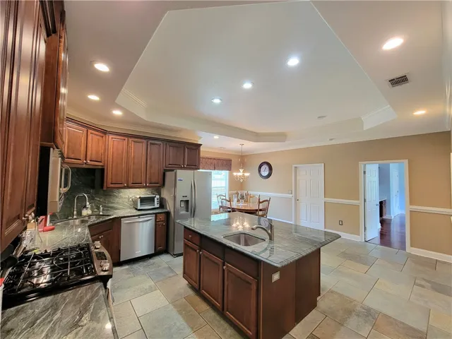 Culinary delights await in this generous kitchen with an island and ample storage.