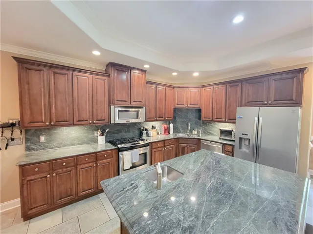 Culinary dreams come alive with this kitchen island featuring an integrated sink.