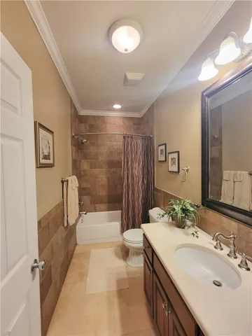 A well-appointed bathroom features a practical tub and shower combination with stylish tile surround.
