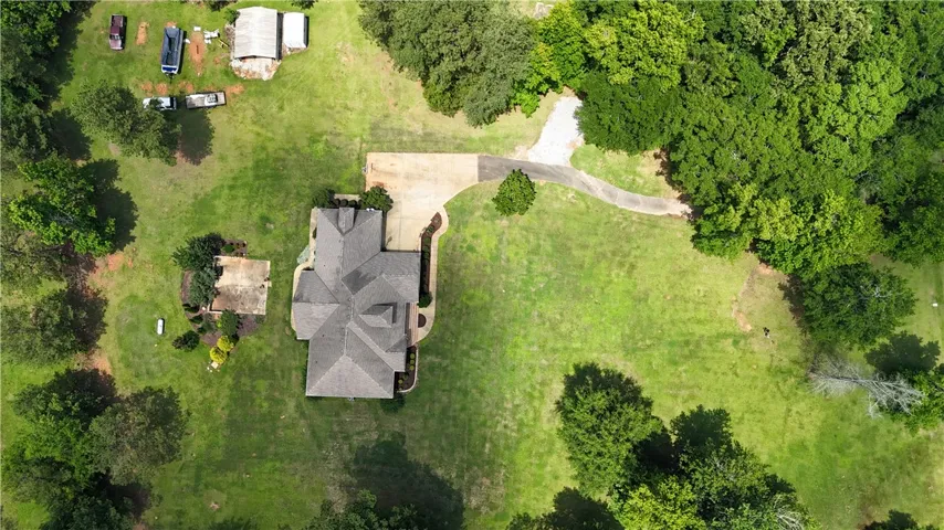 Discover a private estate with a sprawling lawn and mature trees, offering a serene escape.