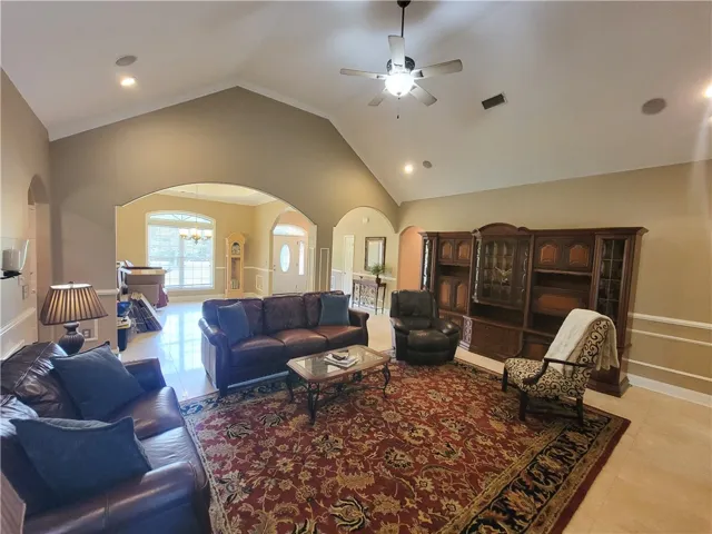 Vaulted ceilings and elegant arched doorways define this grand living space.