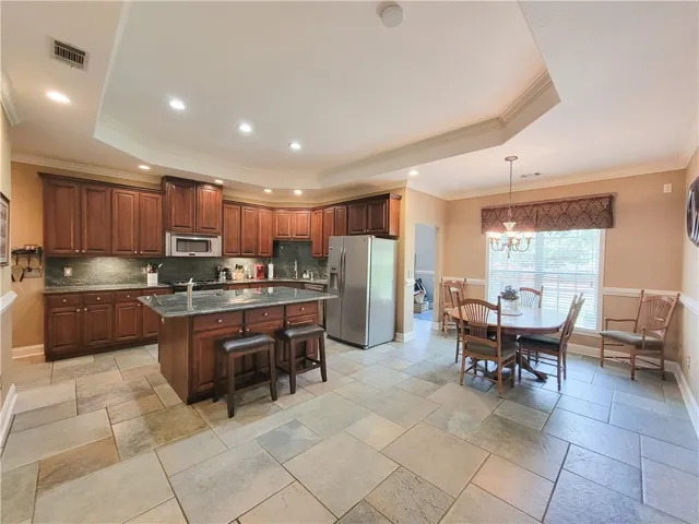 A well-appointed kitchen and dining area provides generous space for culinary pursuits and entertaining.