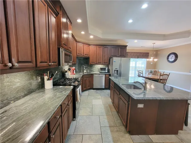 Premium granite countertops complement rich cabinetry in this inviting kitchen, perfect for culinary adventures.