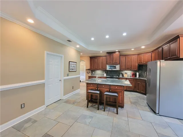 Chef's dream kitchen offers rich wood cabinetry, granite countertops, and modern stainless steel appliances.