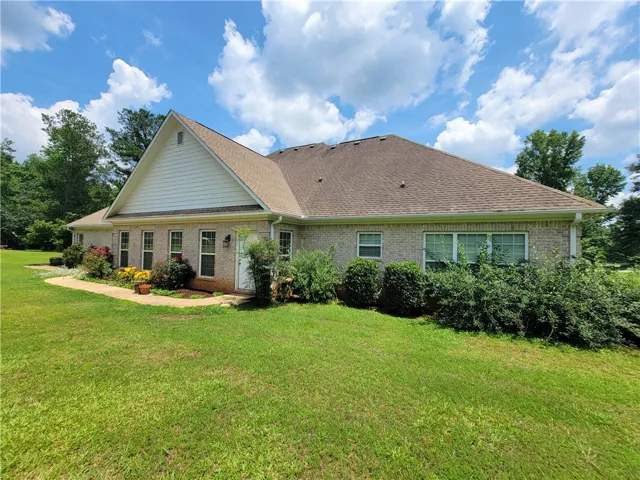 Well-maintained brick residence with a charming front garden and mature landscaping.