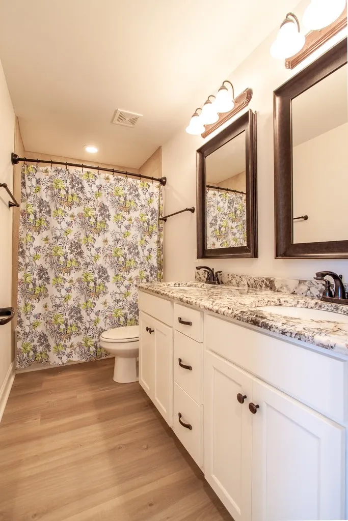 The shared bath has floor to ceiling tile plus double vanities.