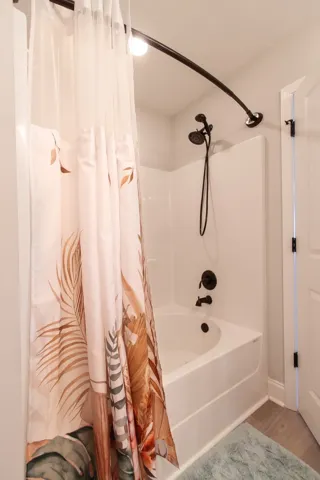 WARNING:  The hand-held and rain showerhead with the curved shower curtain rod can lead to long, relaxing showers.
