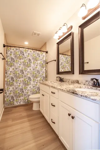 The shared bath has floor to ceiling tile plus double vanities.