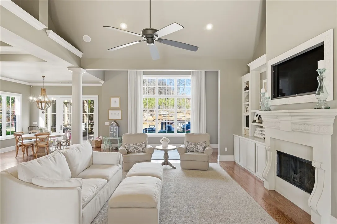 A refined living space showcases a built-in media center, an elegant fireplace, and abundant natural light.