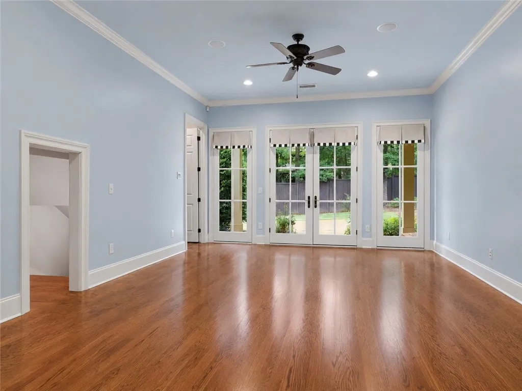 Natural light floods this room, highlighting the warm tones of the hardwood flooring and inviting backyard views.