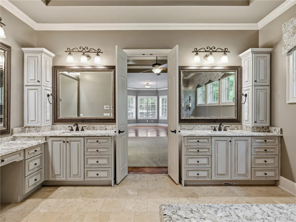 Two individual vanity sinks with ample counter space create a functional and comfortable primary bathroom.