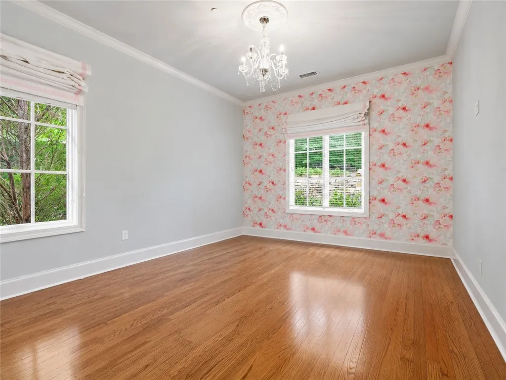 Warm hardwood floors and abundant natural light create an inviting atmosphere.