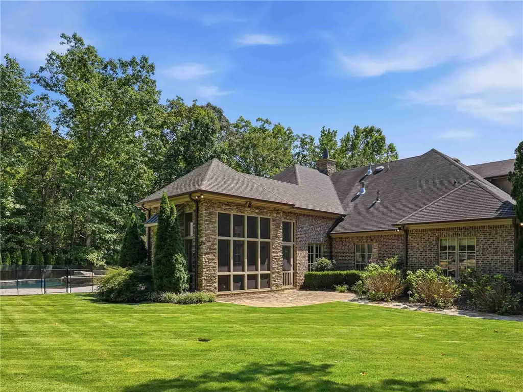 A flagstone patio provides a pleasant outdoor setting for this elegant brick and stone residence.