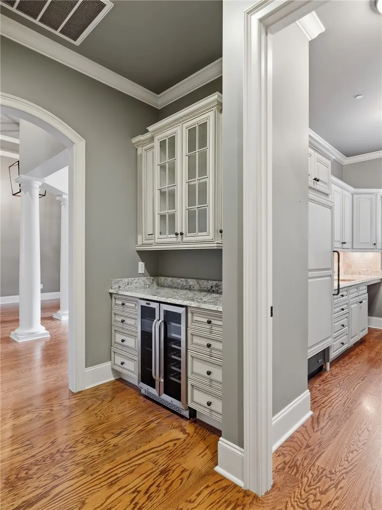 Custom cabinetry and built-in wine cooler elevate the entertaining experience.