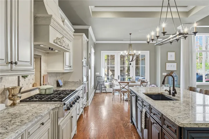 Culinary delights await in this bright kitchen with a spacious island, premium appliances, and charming French doors.