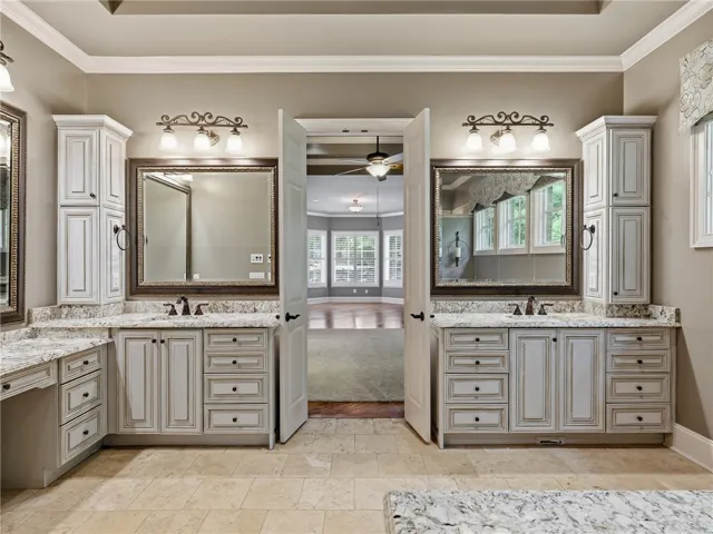 Two individual vanity sinks with ample counter space create a functional and comfortable primary bathroom.