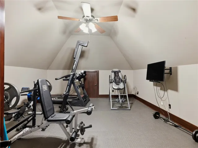 Fitness haven with vaulted ceilings and ample space for exercise equipment.