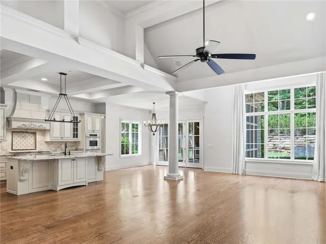 Gleaming hardwood floors and a lofty vaulted ceiling anchor this seamless open-concept living space.
