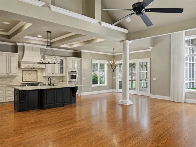 A grand living space with a gourmet kitchen and rich hardwood flooring, perfect for entertaining.