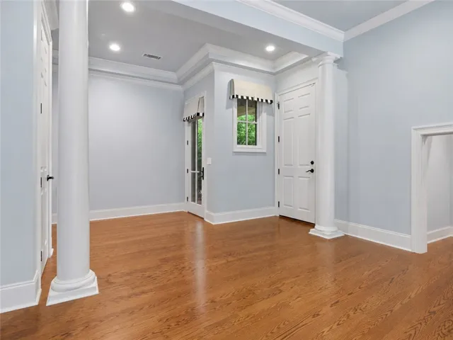 Hardwood floors and bright walls highlight this inviting interior space which can serve as a additional living room playroom or office