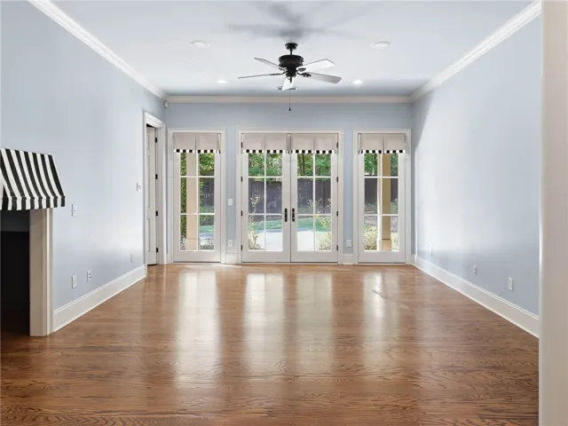 Gleaming hardwood floors and classic crown molding frame space which can serve as a additional living room playroom or office